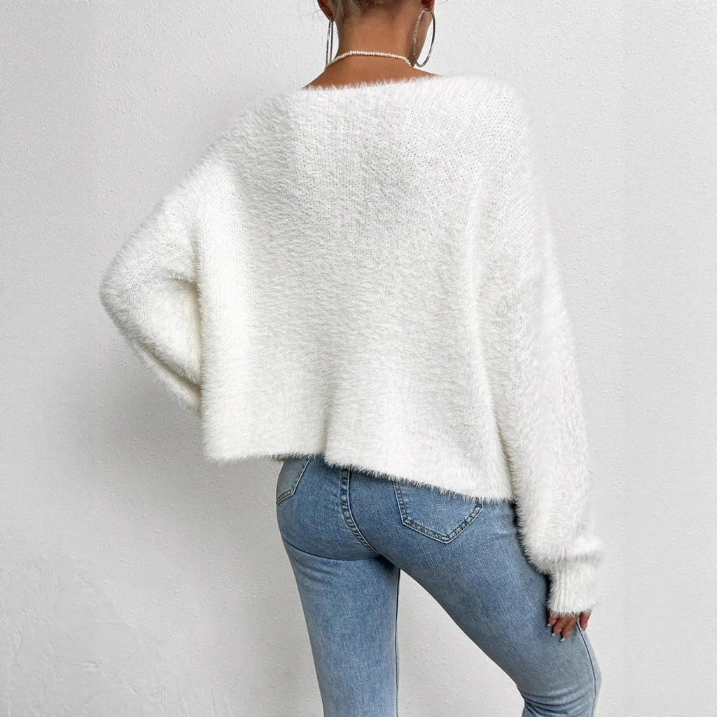 White women's V-neck cardigan sweater with bead-knit texture on a hanger.