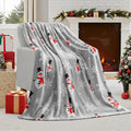 Soft red polyester flannel Christmas blanket folded on a bed