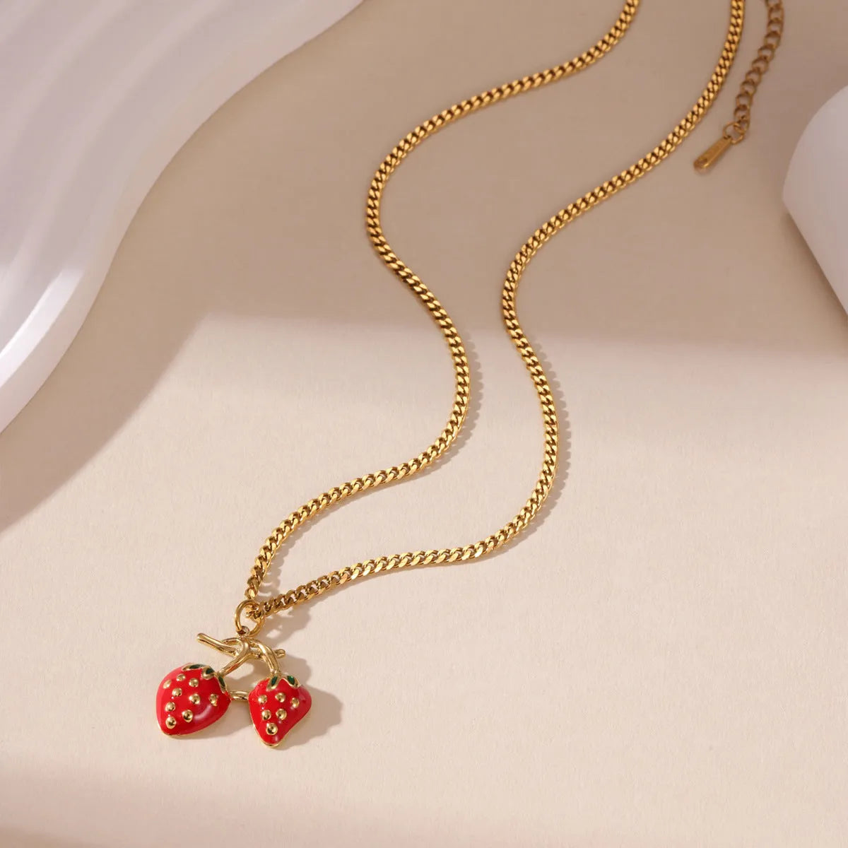Women's strawberry-shaped alloy pendant necklace on a stainless steel chain in red or white powder gradient colour.