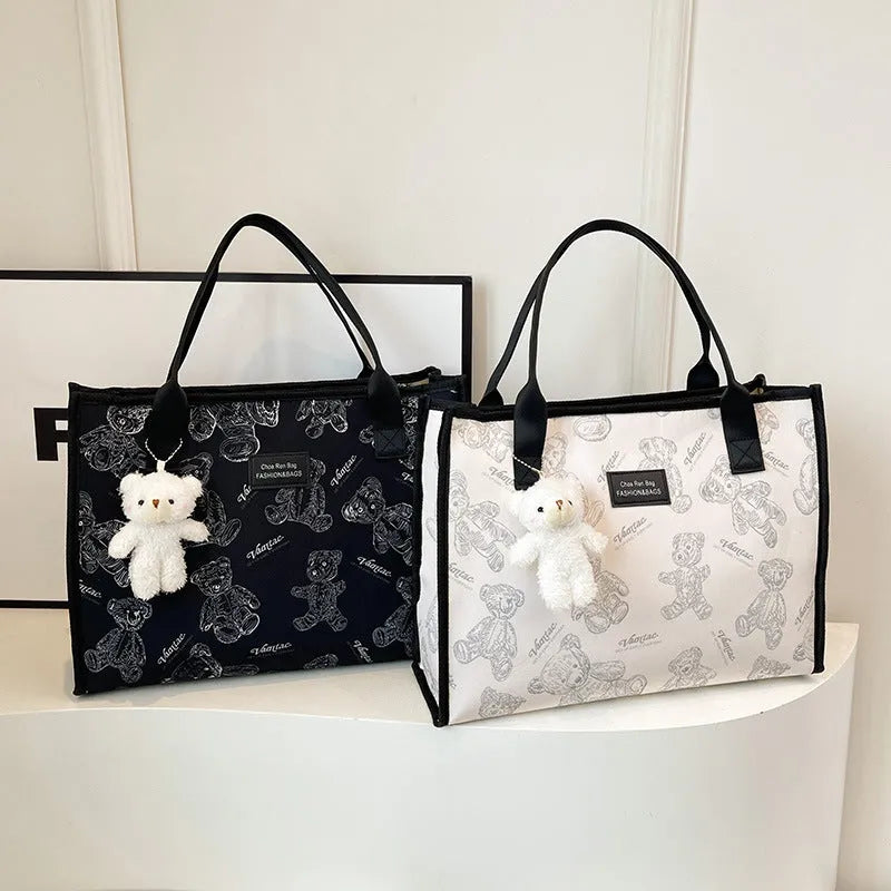 Women's black and white rhombus pattern canvas tote bag with shoulder strap showing horizontal square shape