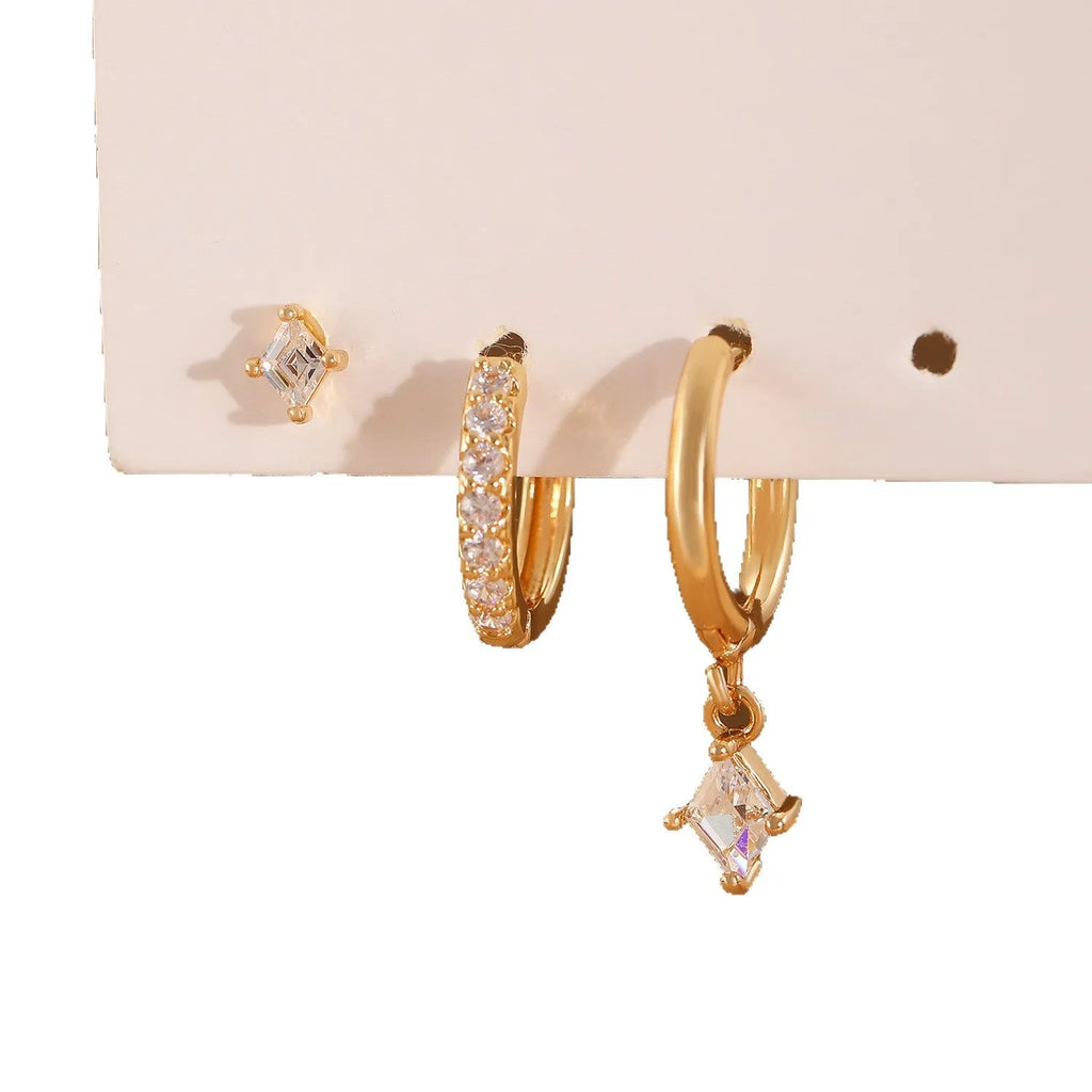 Geometric zircon three-piece earring set showing pendant, stud, and clip styles in gold finish