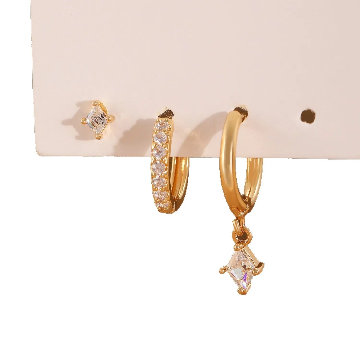 Geometric zircon three-piece earring set showing pendant, stud, and clip styles in gold finish