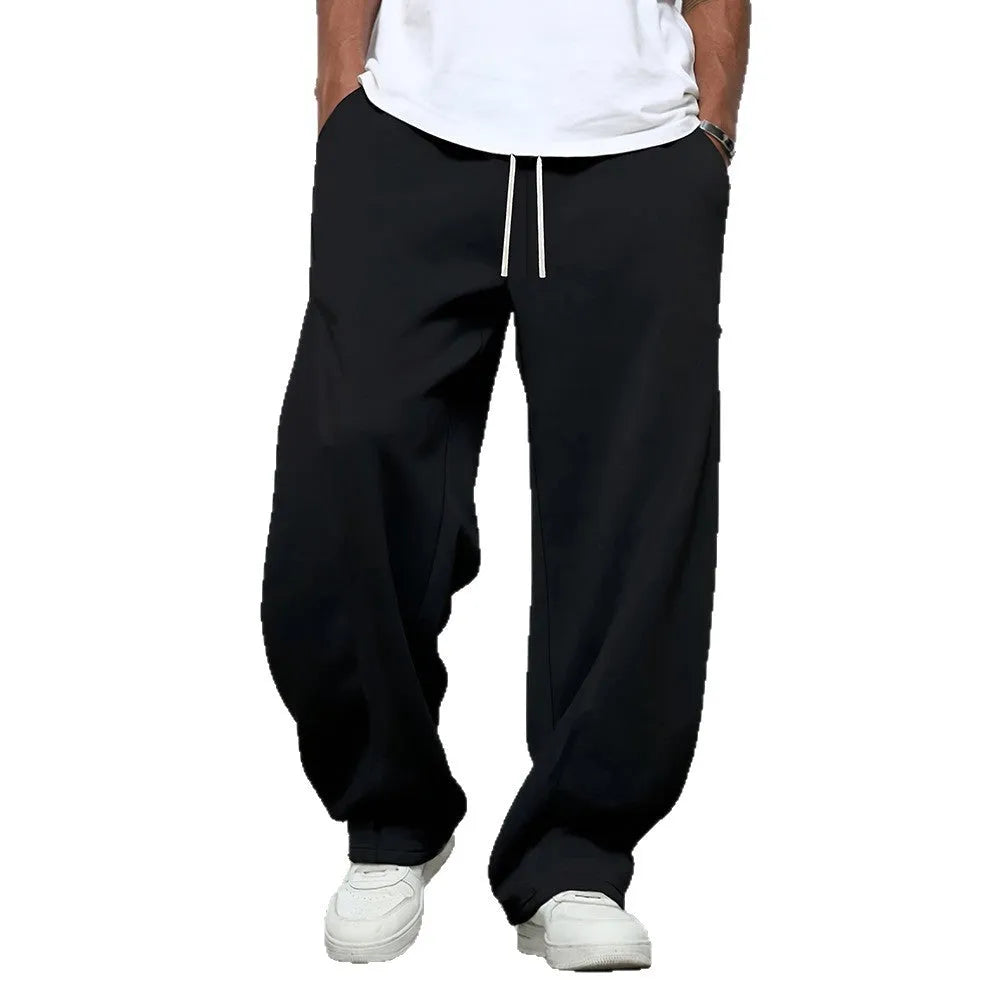 Men's straight-leg polyester casual trousers in black with a drawstring elastic waistband.