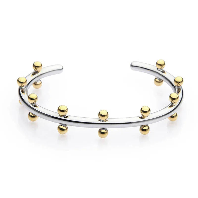 Close-up of stainless steel C-shaped textured bean beads in gold, steel, and steel-gold colours.