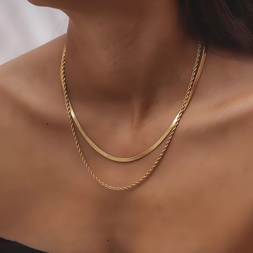 Close-up of a women's gold retro double-layer twist necklace with a geometric pendant on an adjustable chain.