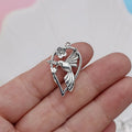 Close-up of an alloy magpie bird pendant charm with electroplated finish for DIY jewellery.
