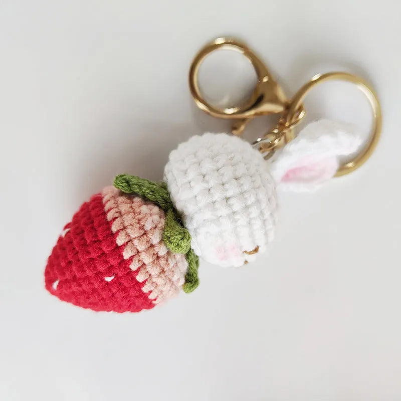 Hand-woven colourful wire pendant shaped like a rabbit with a strawberry, featuring a key loop.