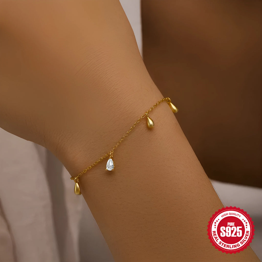 Gold S925 sterling silver bracelet with water drop diamond pendant on a geometric chain.