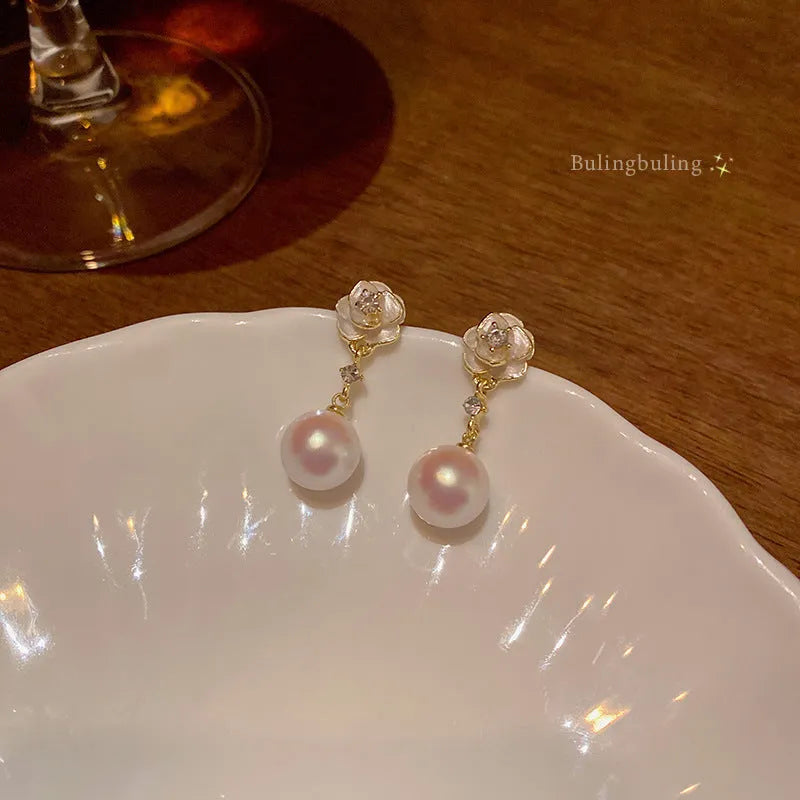 Camellia flower stud earrings with pearl centrepiece on alloy backing