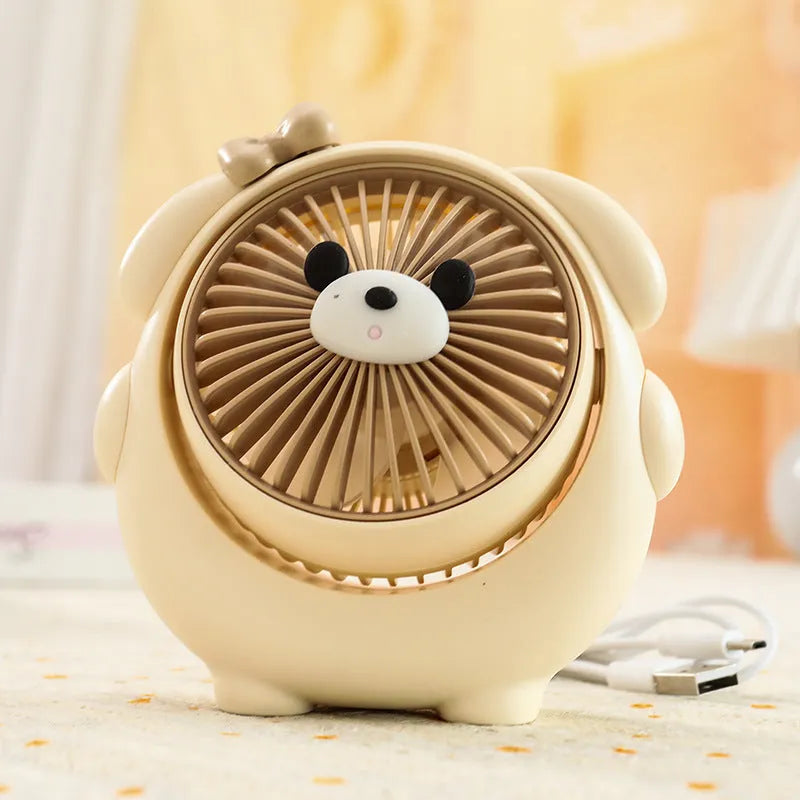 Cute dog-themed desktop electric fan with USB cable and multiple colour options on a desk.