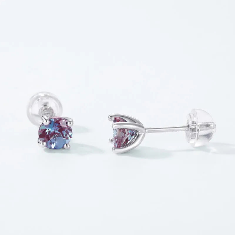 A pair of sterling silver geometric circle ear studs with a cultivated alexandrite stone.