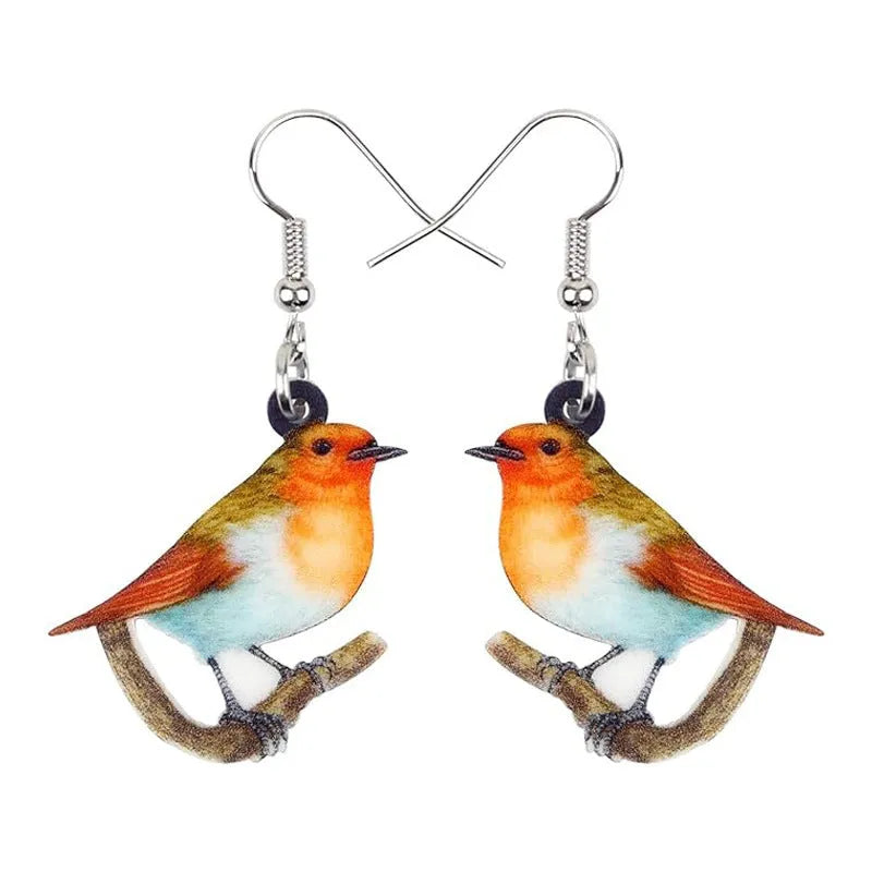 Close-up of blue titmouse and snake geometric design on women's acrylic pendant earrings.