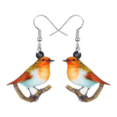 Close-up of blue titmouse and snake geometric design on women's acrylic pendant earrings.