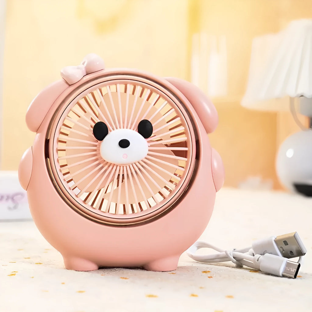 Cute dog-themed desktop electric fan with USB cable and multiple colour options on a desk.