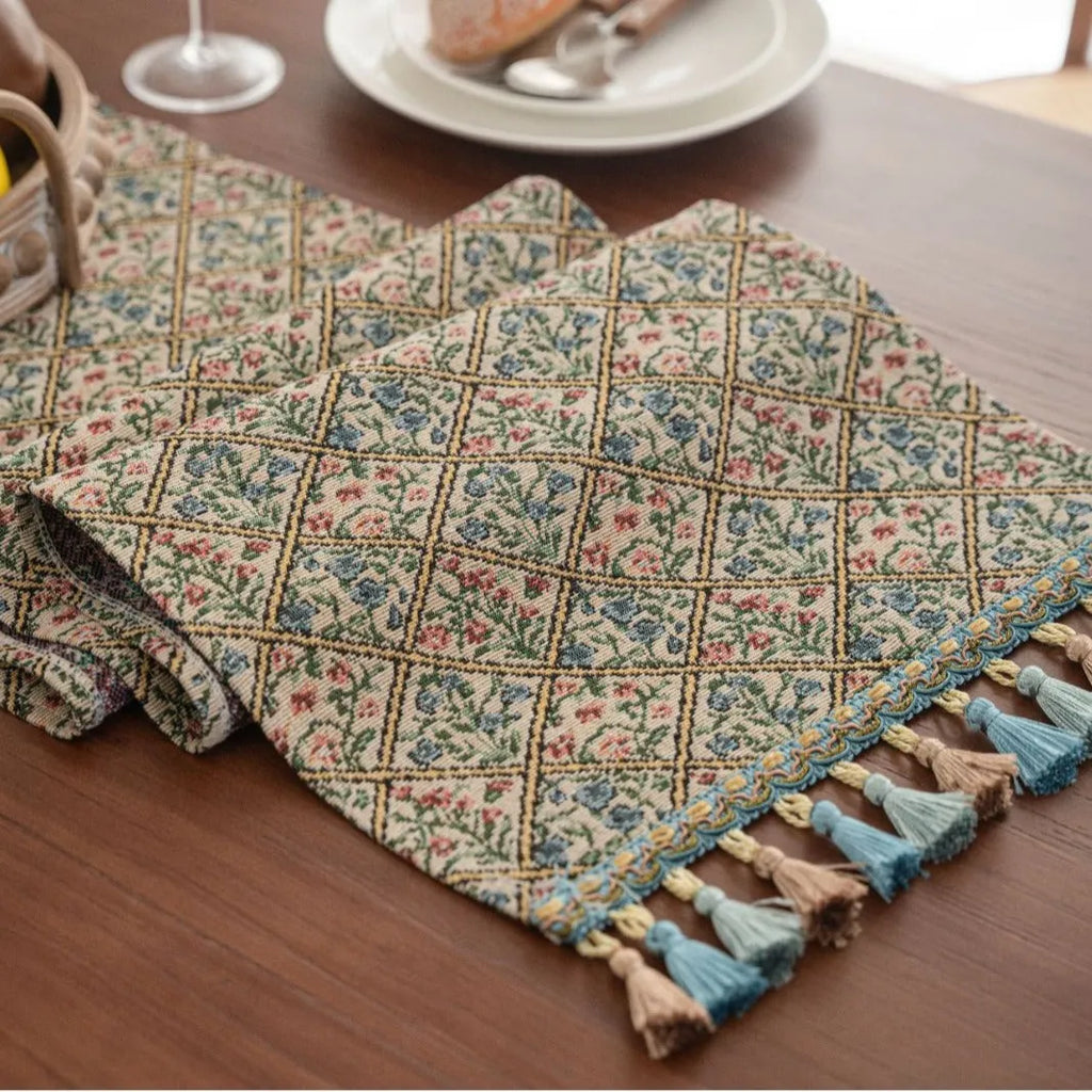 Nordic jacquard table runner with tassel fringe in dark blue with striped pattern on wooden table