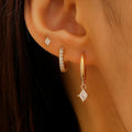 Geometric zircon three-piece earring set showing pendant, stud, and clip styles in gold finish