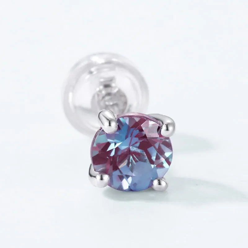 A pair of sterling silver geometric circle ear studs with a cultivated alexandrite stone.
