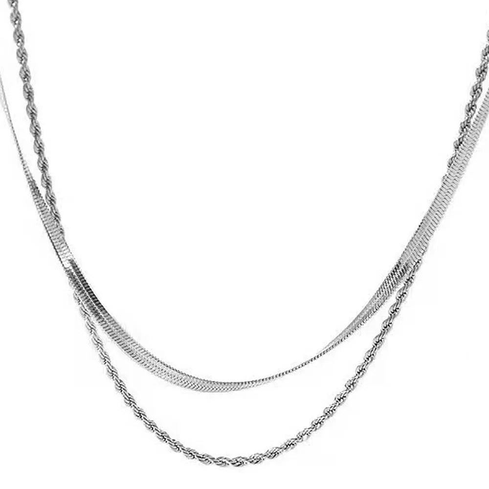 Close-up of a women's gold retro double-layer twist necklace with a geometric pendant on an adjustable chain.