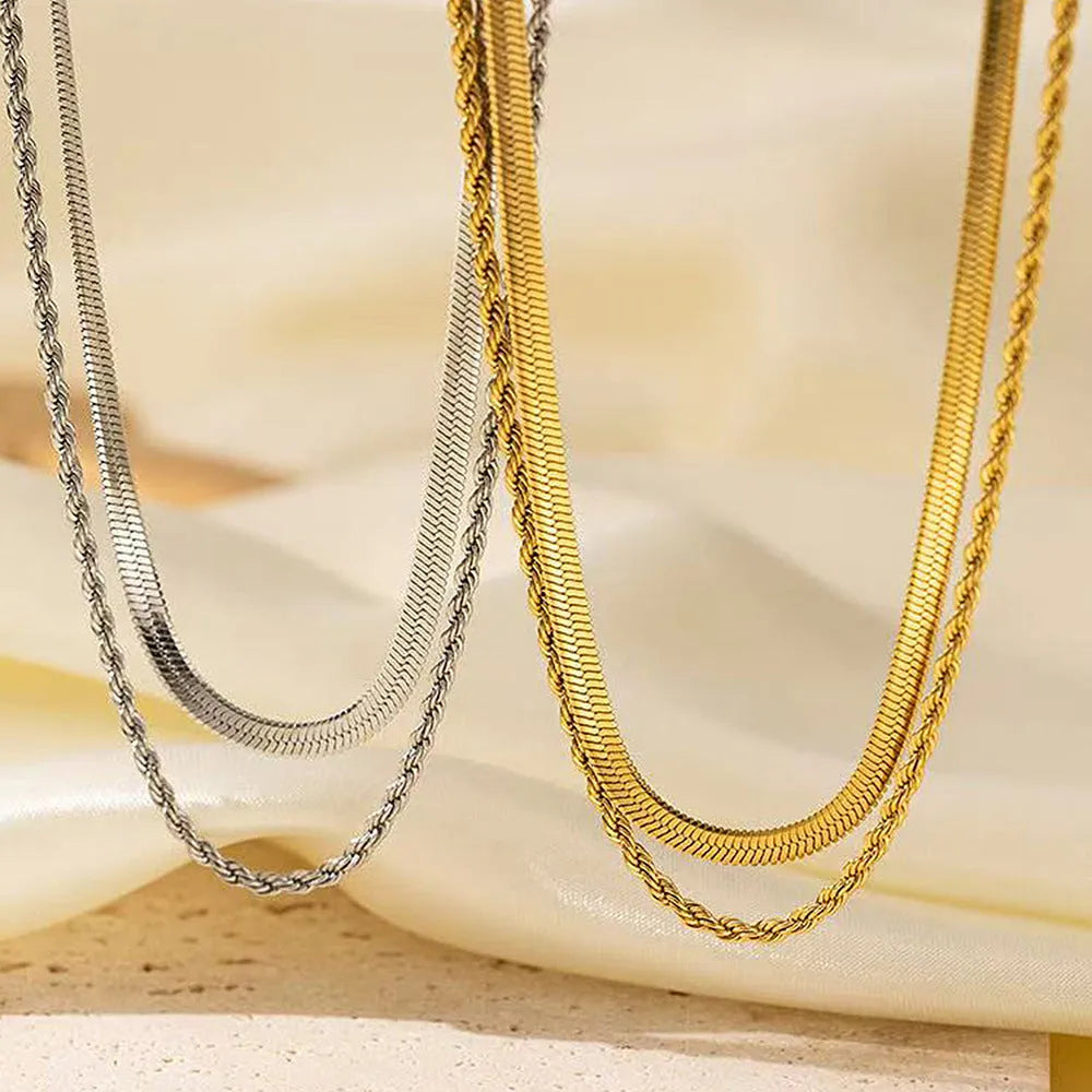 Close-up of a women's gold retro double-layer twist necklace with a geometric pendant on an adjustable chain.