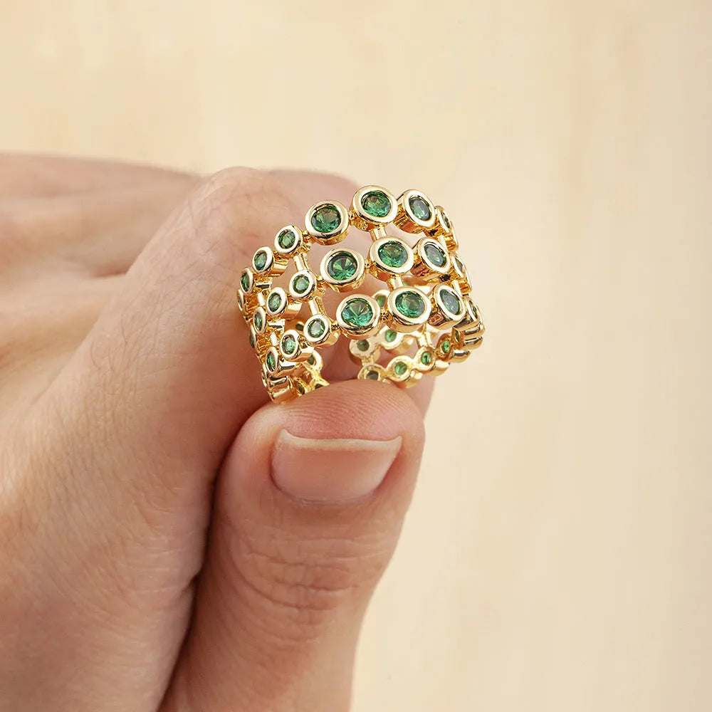 Three-layer wide band statement ring with green zircon stones and gold plating on copper base