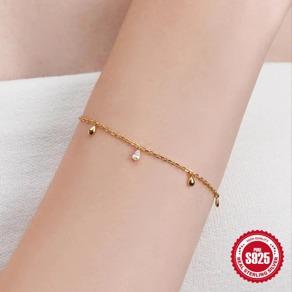 Gold S925 sterling silver bracelet with water drop diamond pendant on a geometric chain.