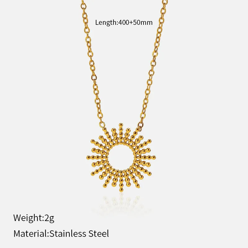 Gold geometric chain necklace and matching bracelet set on a plain background.