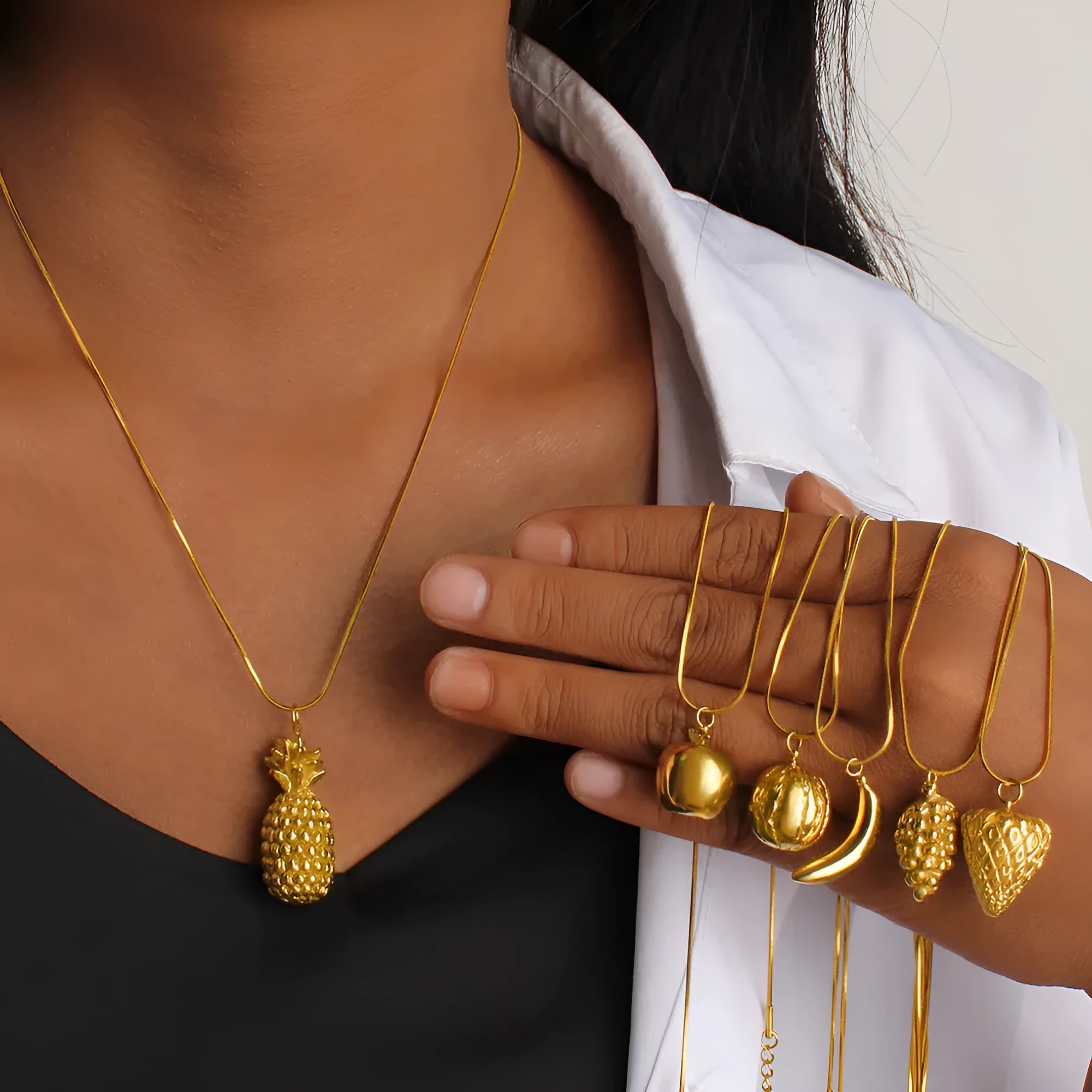 Alloy fruit pendant necklace with apple, grape, watermelon, banana, pineapple, strawberry designs on stainless steel chain.