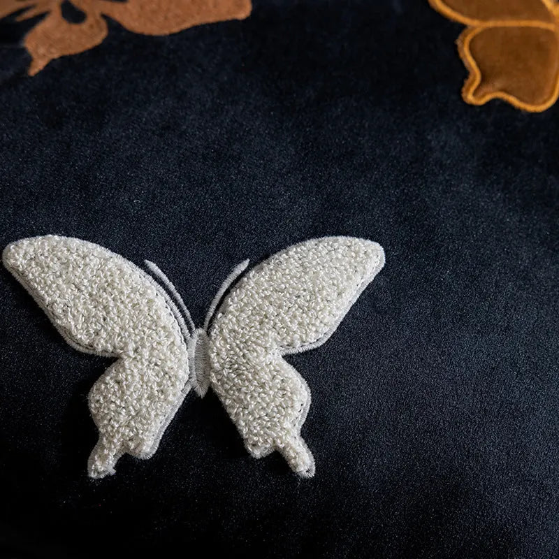 Square beige cushion with detailed black butterfly embroidery in a Chinese style.