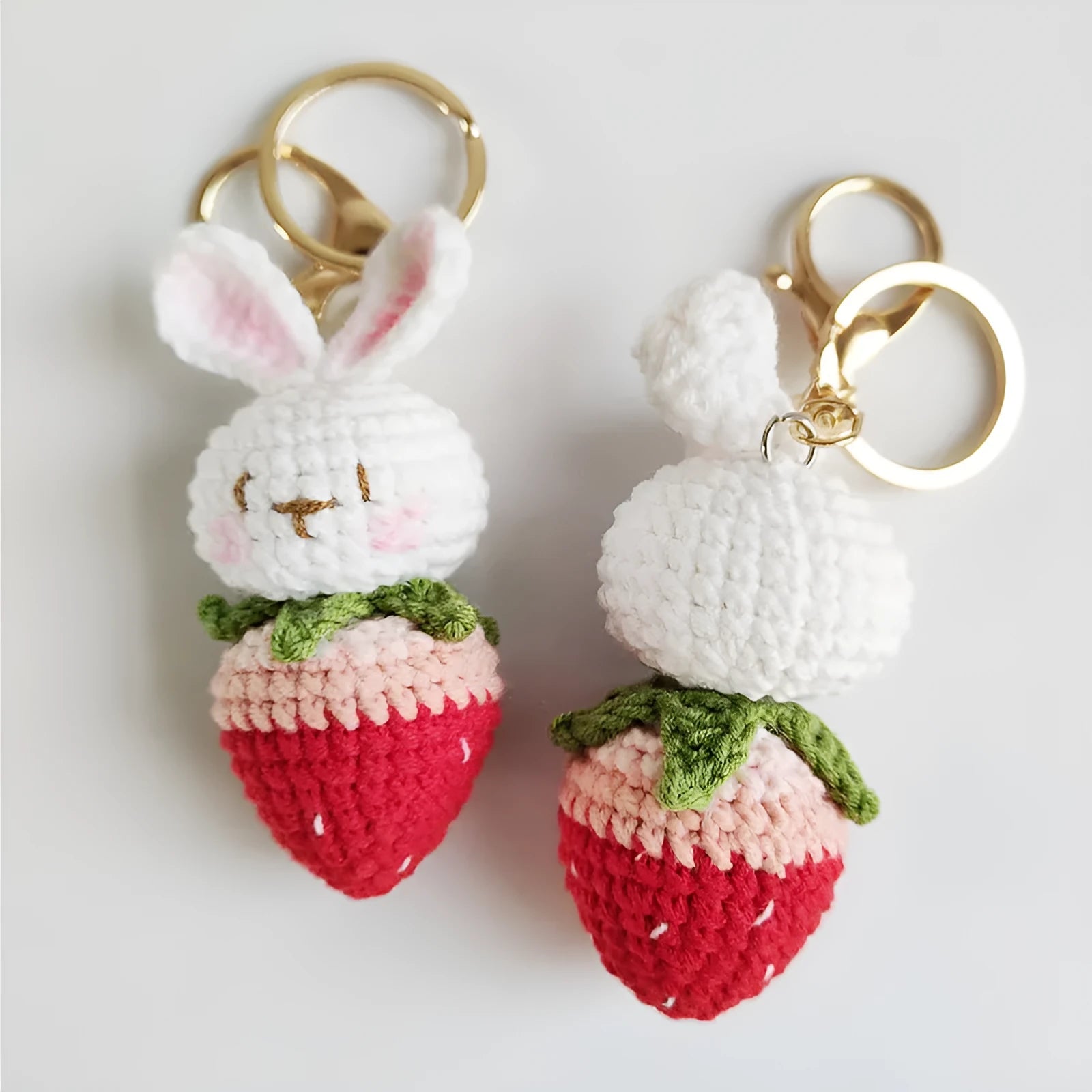 Hand-woven colourful wire pendant shaped like a rabbit with a strawberry, featuring a key loop.
