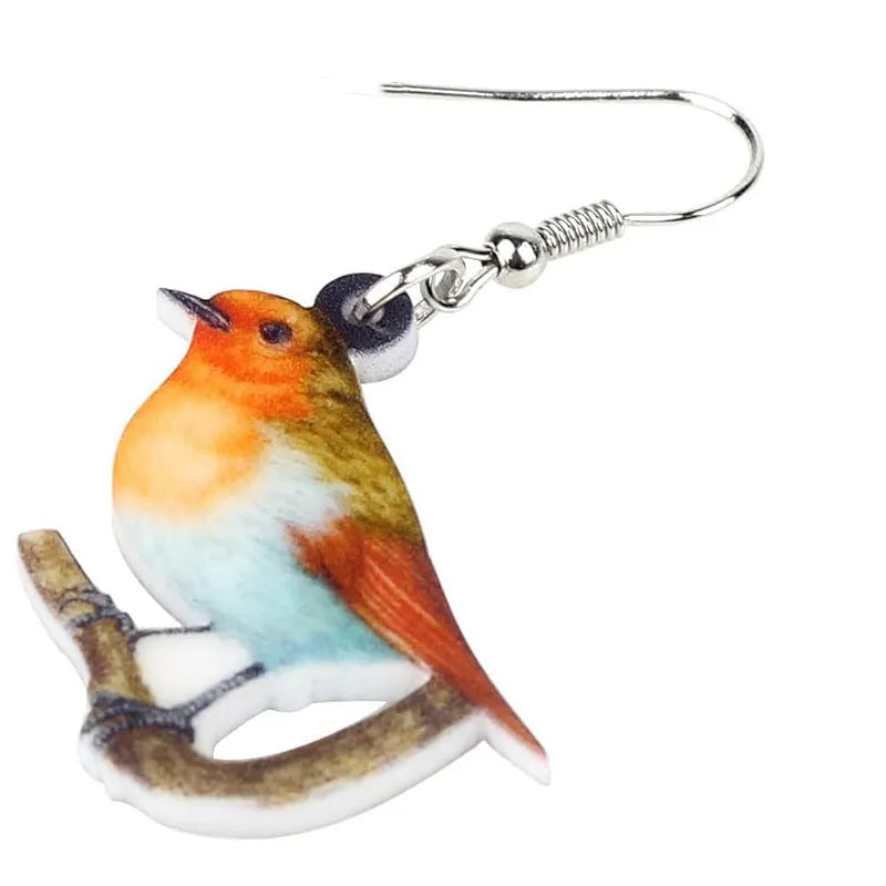 Close-up of blue titmouse and snake geometric design on women's acrylic pendant earrings.