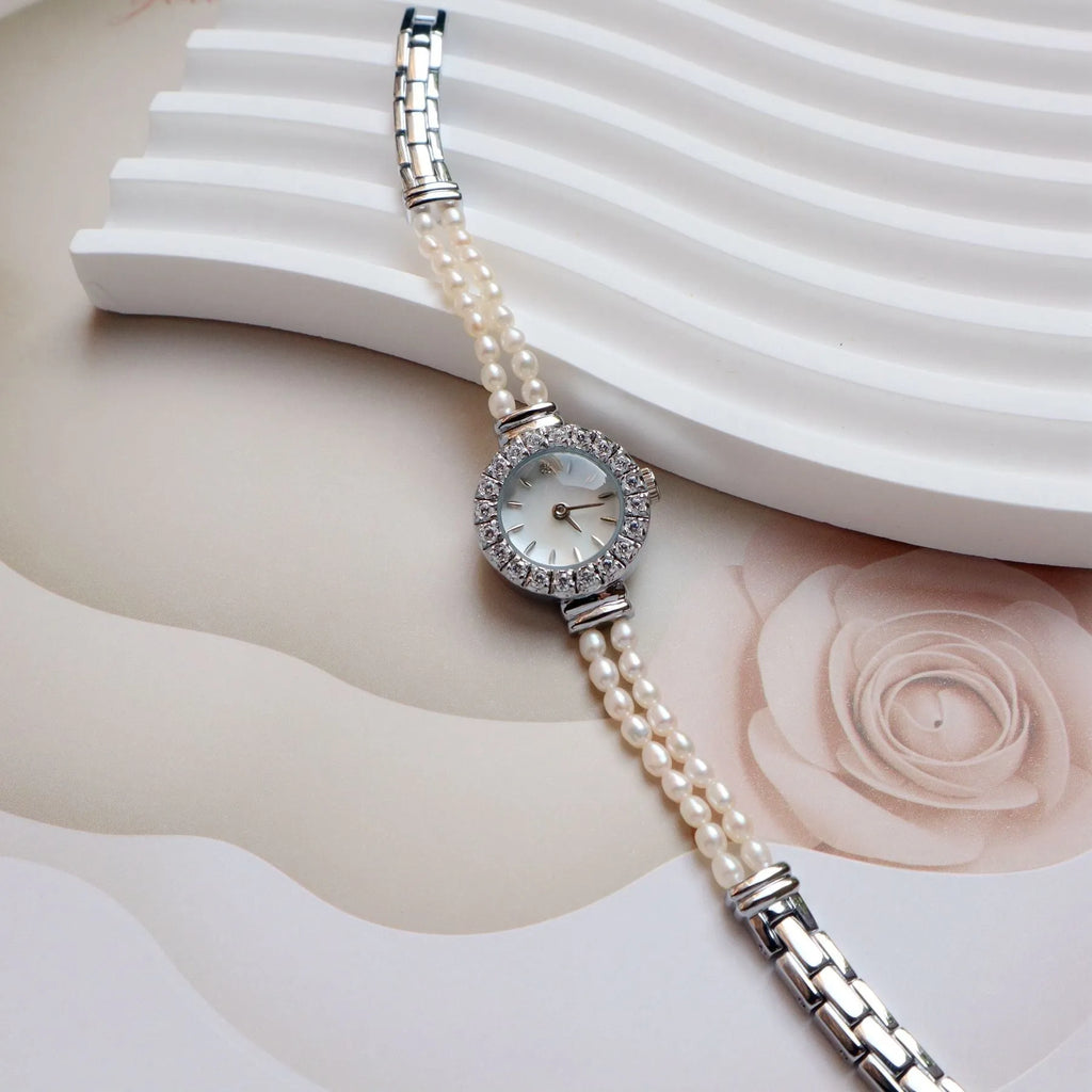 Women's light gold bracelet watch with a freshwater pearl dial and stainless steel strap