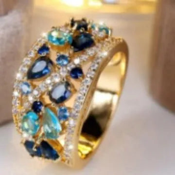 A women's hollow round copper fashion ring shown in a choice of platinum and gold finishes with white or blue accents.