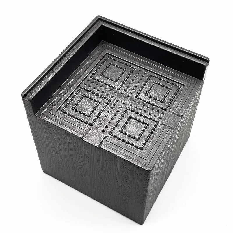 Four black circular plastic foot mats for furniture height increasing.