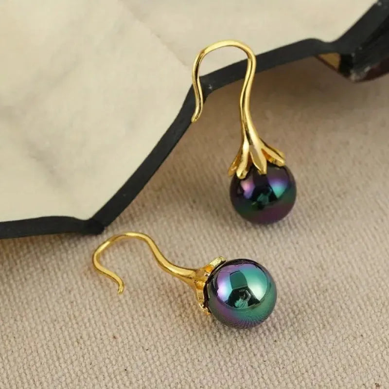 A pair of gold-coloured retro fashion earrings for women, made from electroplated alloy.