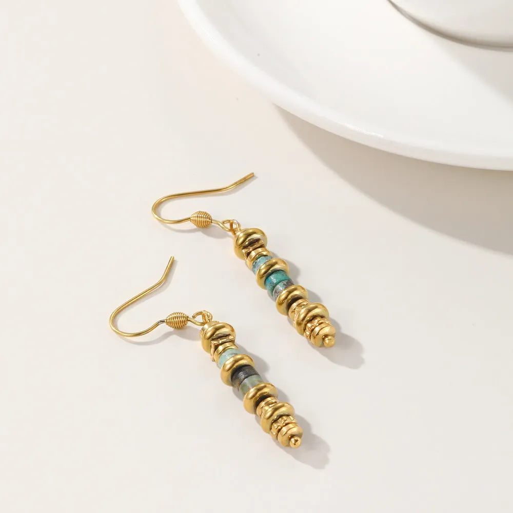 A pair of women's geometric retro dangle earrings in titanium steel with an 18K finish.