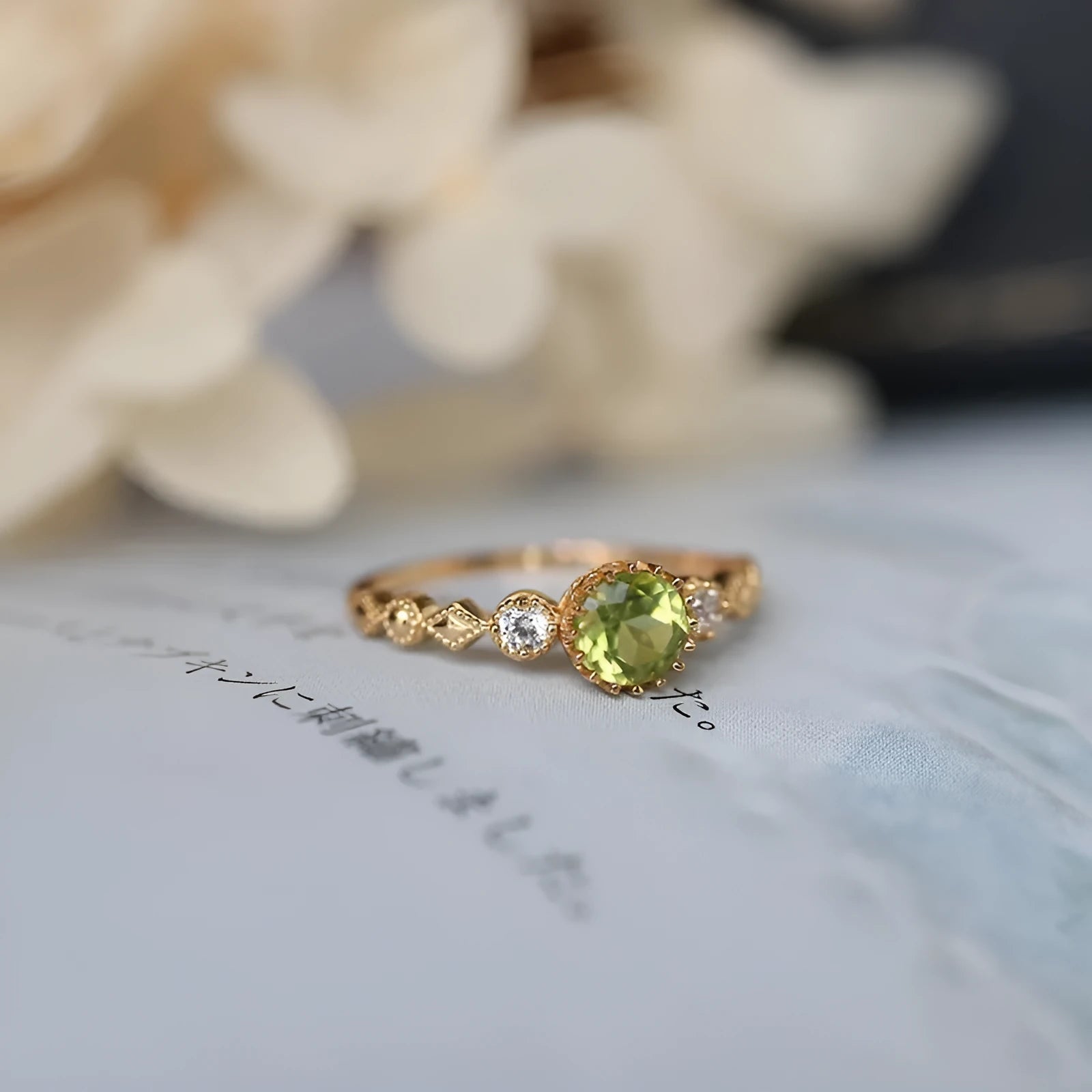 Japanese style geometric copper ring with green imitation peridot stone on a hand.