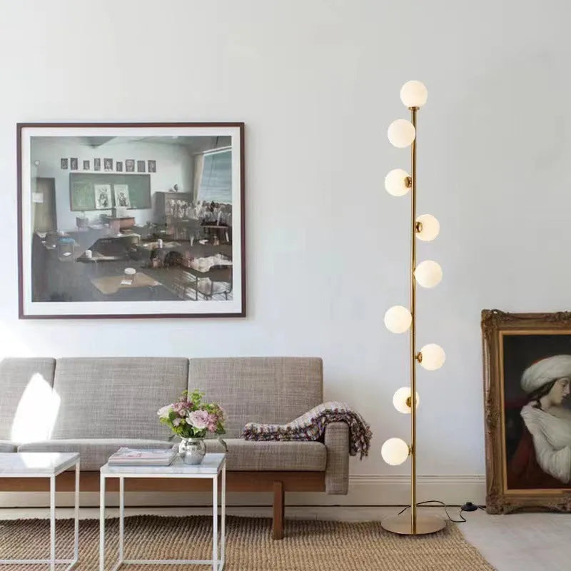 Tall minimalist Nordic style floor lamp with iron frame and glass shade on a stable iron base.