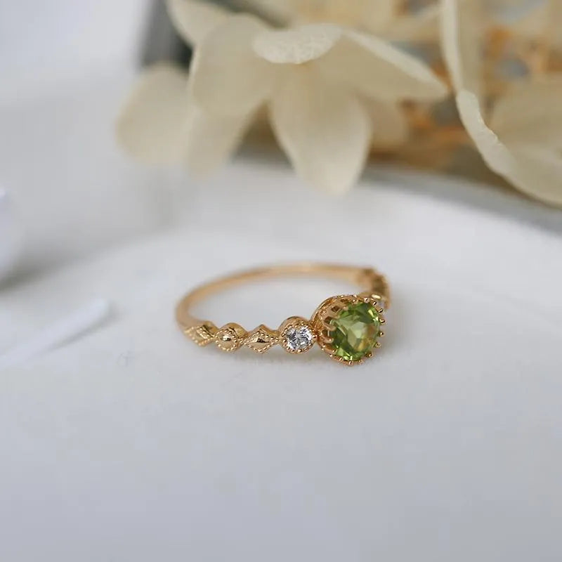 Japanese style geometric copper ring with green imitation peridot stone on a hand.