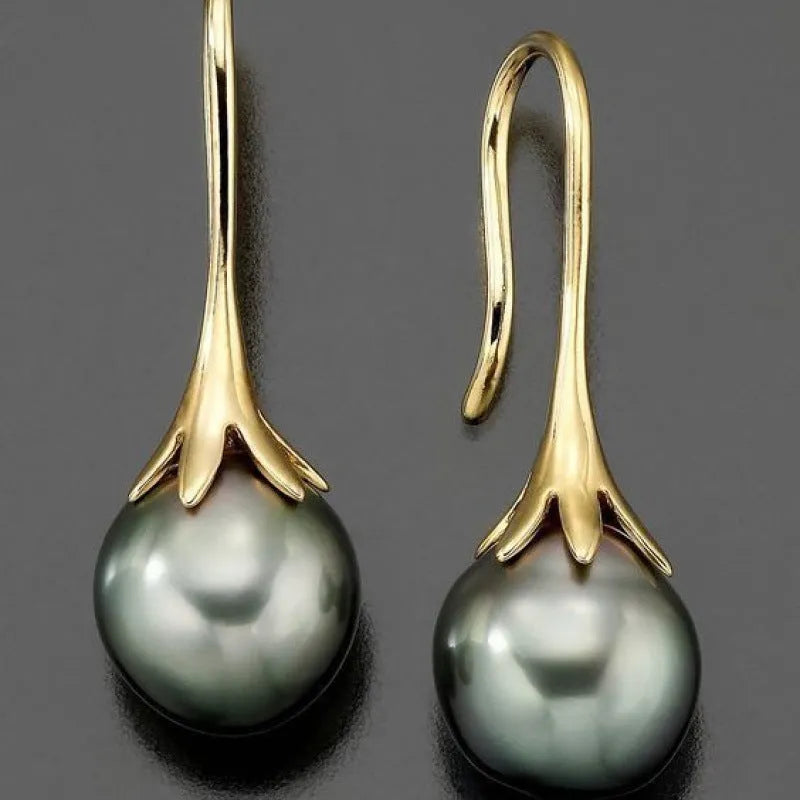 A pair of gold-coloured retro fashion earrings for women, made from electroplated alloy.