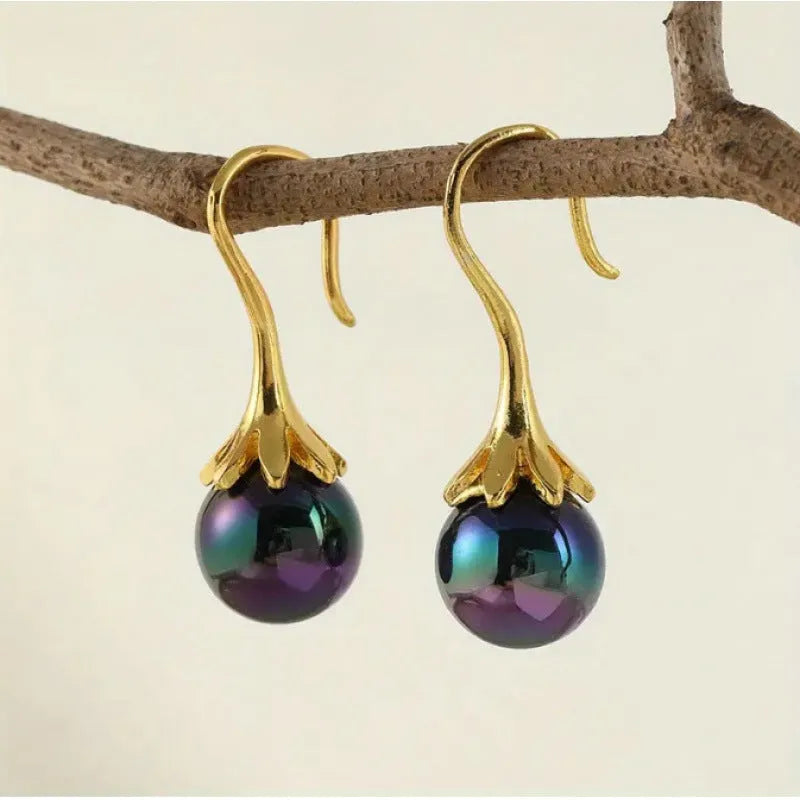 A pair of gold-coloured retro fashion earrings for women, made from electroplated alloy.