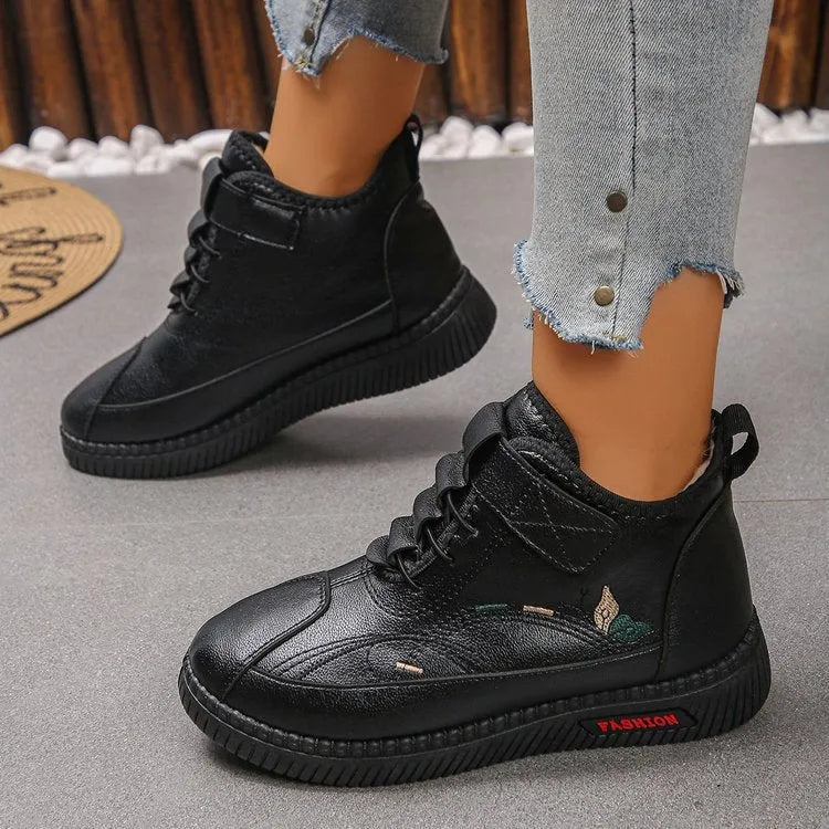 Women's black velvet low-top shoes with a non-slip rubber sole and hollow out design on a white background.