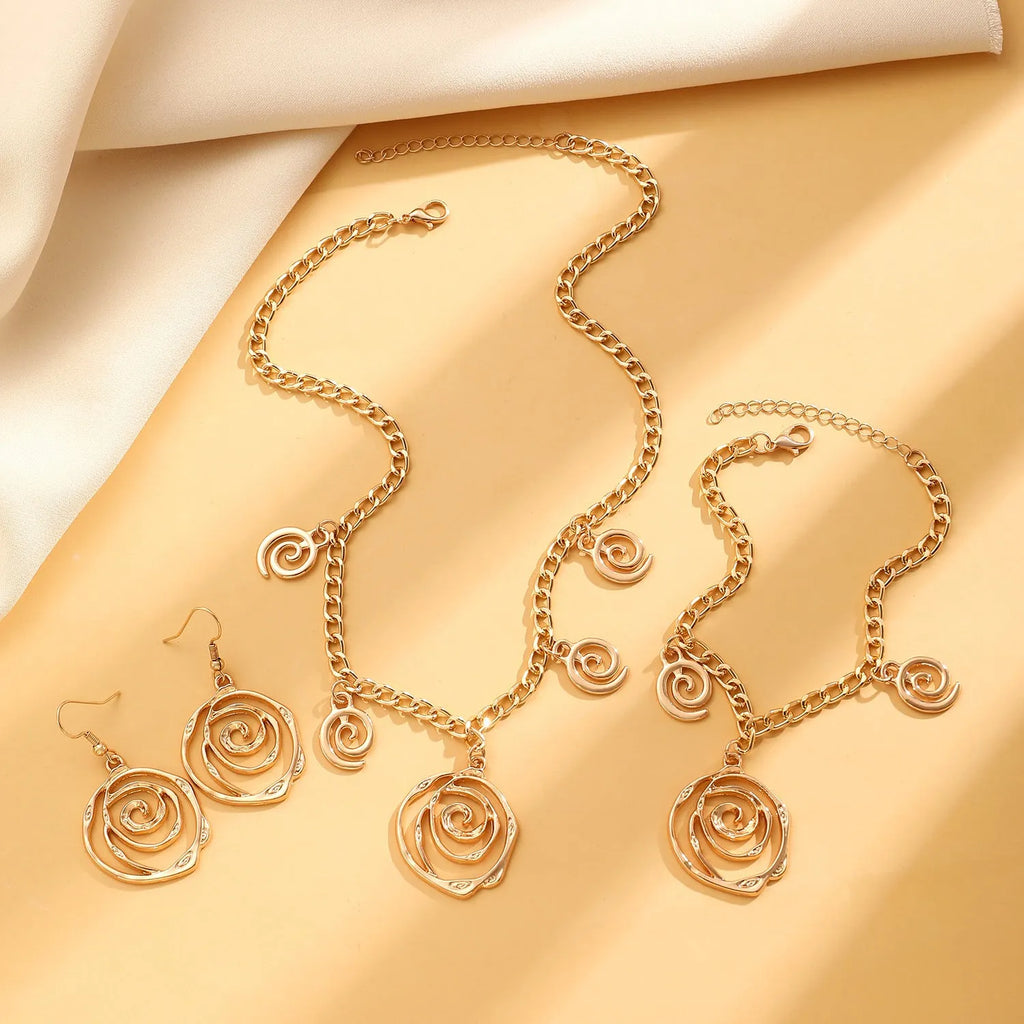 Spiral donut jewellery set showing necklace, bracelet, and earrings in geometric circle design with gold finish