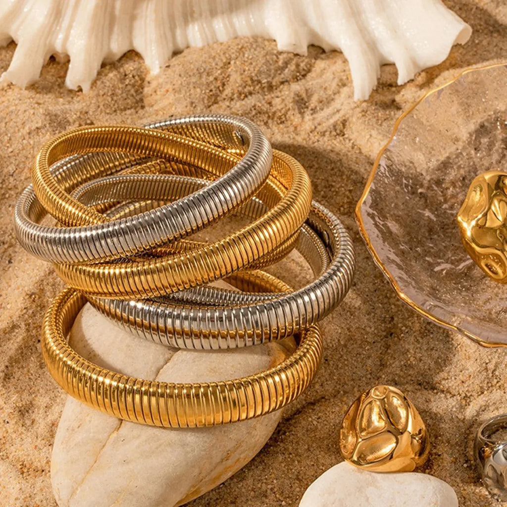 Women's titanium steel bracelet with vertical stripe ring design in gold or silver colour