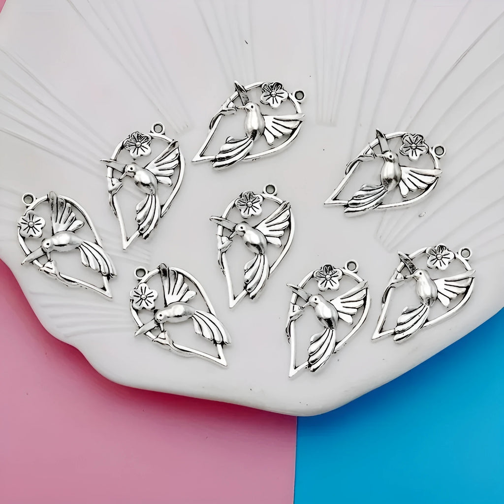 Close-up of an alloy magpie bird pendant charm with electroplated finish for DIY jewellery.