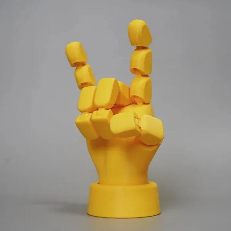 Yellow movable joint hand prop ornament on a white background.