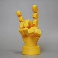 Yellow movable joint hand prop ornament on a white background.
