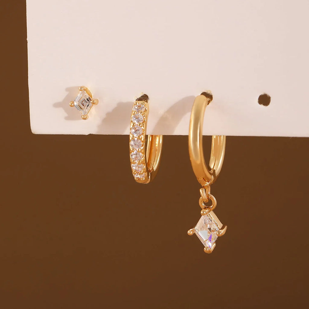 Geometric zircon three-piece earring set showing pendant, stud, and clip styles in gold finish