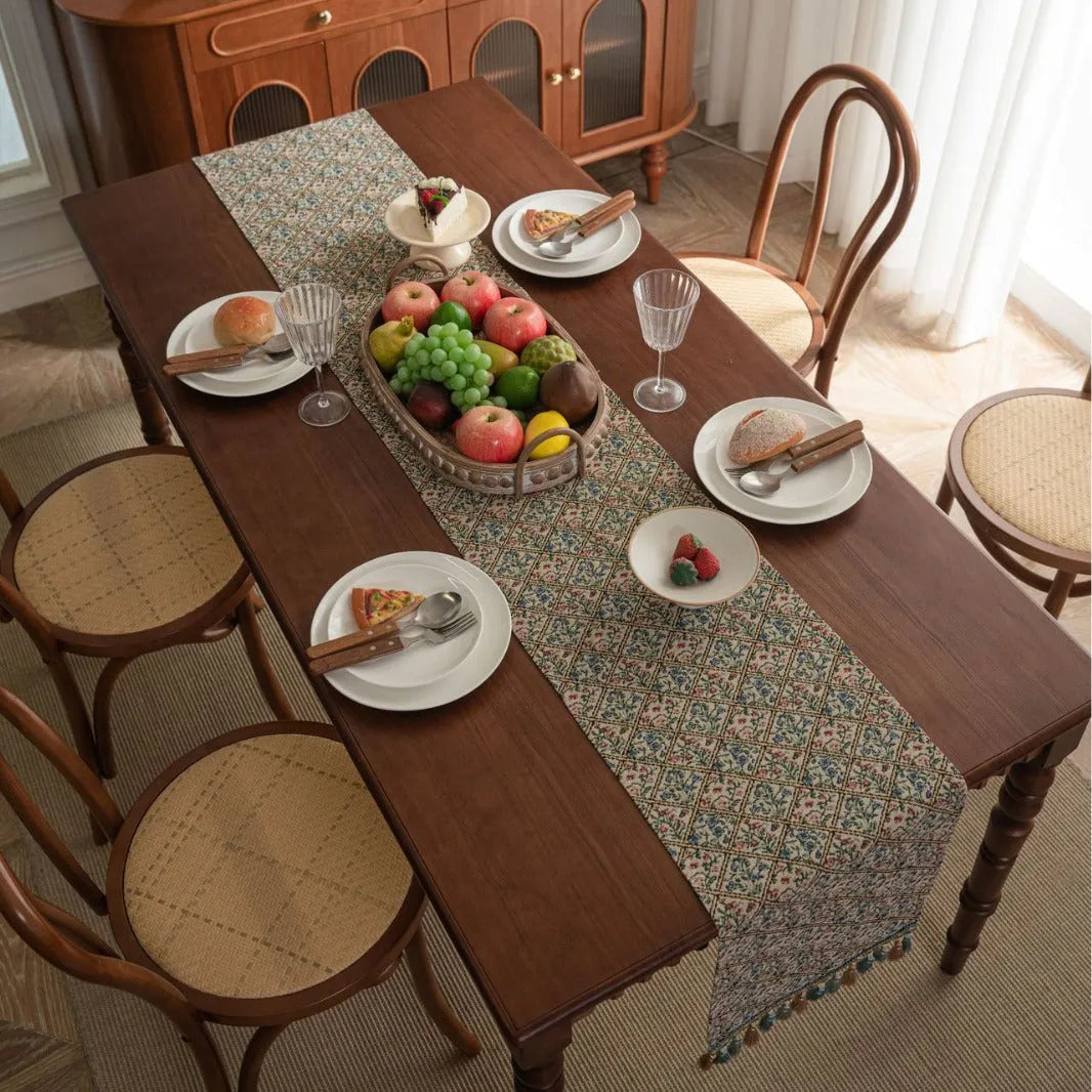 Nordic jacquard table runner with tassel fringe in dark blue with striped pattern on wooden table
