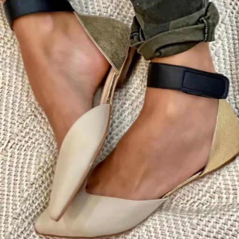 Women's beige velcro sandals with a hollowed flat heel design on a white background.