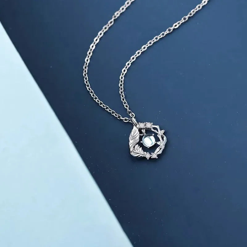 Geometric tree and bluebird pendant necklace on adjustable chain with eucalyptus blue colour option